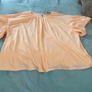 Keyhole back little peachy/pink colored blouse